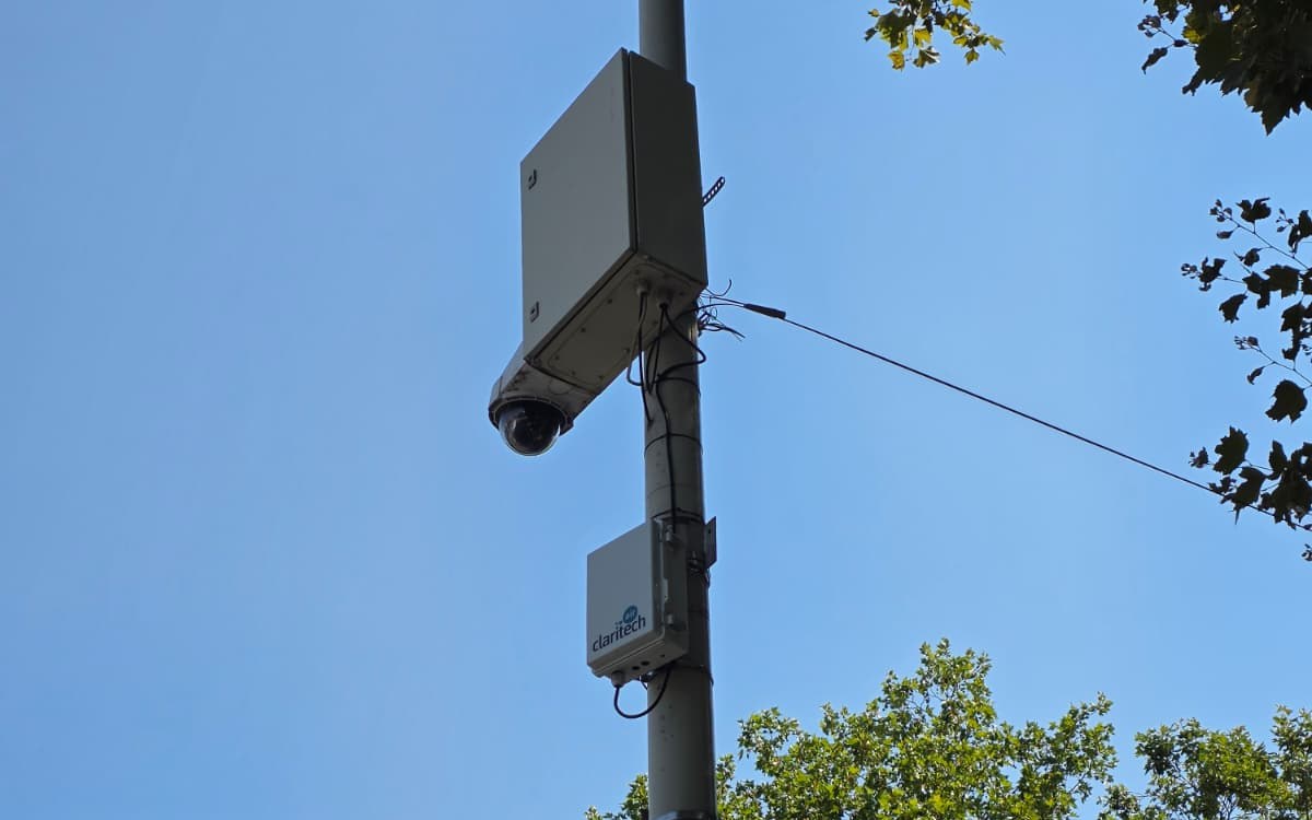 Air-quality monitoring station mounted on a pole, below the city's surveillance equipment