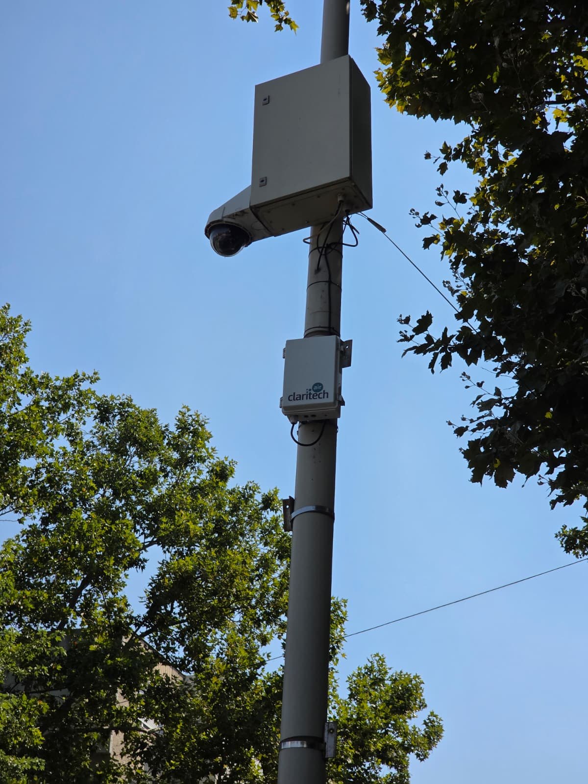 Air monitoring station on a pole, below the city's surveillance equipment
