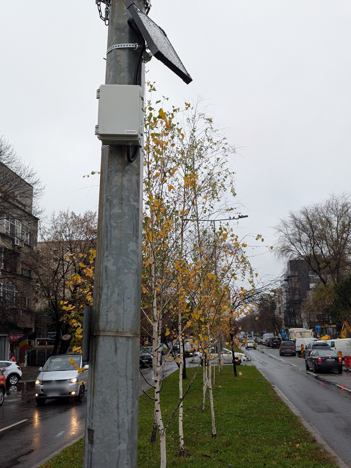 Solar-powered noise measurement station mounted on a pole between the boulevard's carriageways